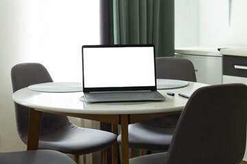 Home office with open laptop computer mockup