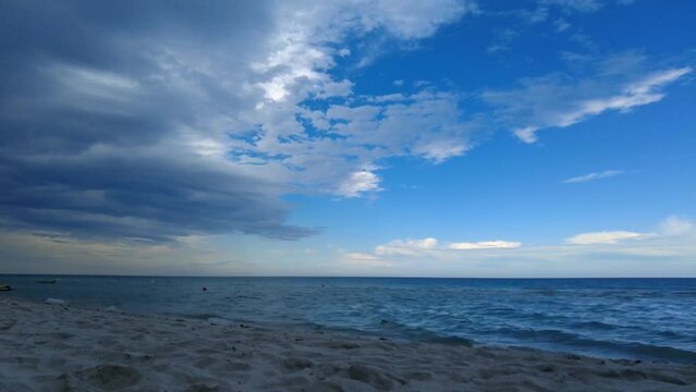 time lapse of clouds over over ocean from the beach