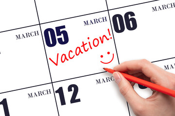 A hand writing a VACATION text and drawing a smiling face on a calendar date 5 March. Vacation...