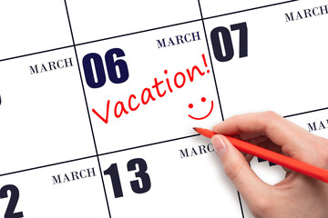 A hand writing a VACATION text and drawing a smiling face on a calendar date 6 March. Vacation...