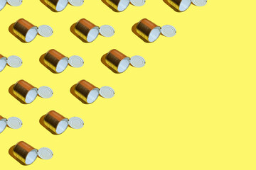 Pattern made of empty metal tin can over yellow background. top view of Mockup or metal tin can design. recycling concept.