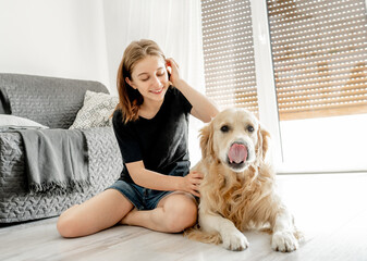 Girl with golden retriever dog