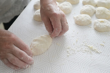 grandmother's hands are preparing pies. Home cooking, baking