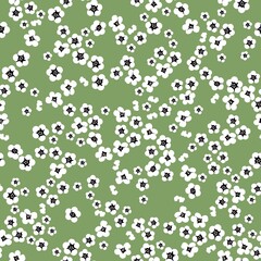 Simple vintage pattern. small white flowers. green background. Fashionable print for textiles and wallpaper.