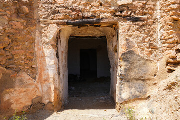 Fototapeta premium Entrance door of a troglodyte cave-house in Guadix - Home dug inside a dirt cliff in Andalusia, in the south of Spain, near the Sierra Nevada