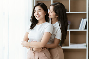 Asian lesbian couple, LGBTQ. Happy Two young Asia women showing love and romance together at home. Positive mood and moment of LGBT lesbian