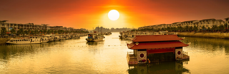 Tuan Chau Pier and Tuan Chau Water Puppet Theater at sunrise.Tourist boat cruise for Halong bay....