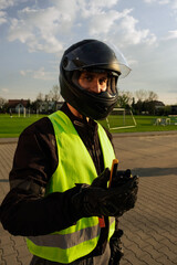 Заголовок	
Motorcyclist in a driving lesson. Lessons in auto and motorcycle school. A student in a special uniform drives a motorcycle. Summer training on a moped. Student and teacher.	
