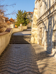 Prague Castle in the spring morning sun. Narrow streets, stairs and wonderful palaces in Prague Castle. A unique sight without a crowd of tourists on a wonderful spring morning. Prague Castle has been