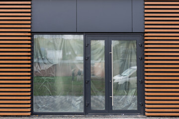 Outside solid glass door with building exterior