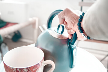 Tea Cup Pouring Water in the Mug