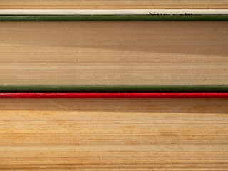 A stack of different old books for the background. Old books with yellowed pages lying one on top of another macro photo. Reading time.