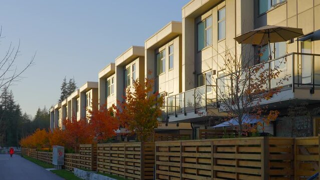 Establishing shot of modern apartment building with beautiful Fall foliage landscape in Vancouver, Canada, North America. Day time on October 2021. ProRes 422 HQ.
