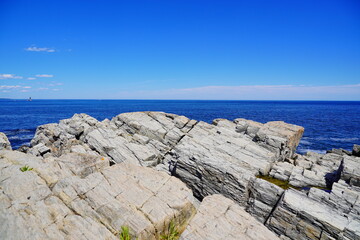 Atlantic ocean waves and rock beach along coastline in Portland, Maine, USA	