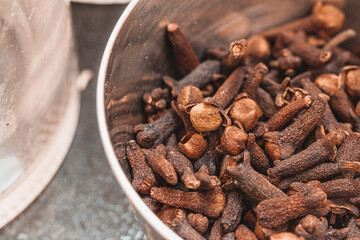 Dried cloves in a steel bowl. Spice clove for favoring.