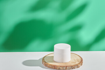 cosmetic product in tube, glass bottle, lotion, anti-aging moisturizer, facial essential oil or serum on green background with light shadow nature. Organic natural and Beauty skincare concept.