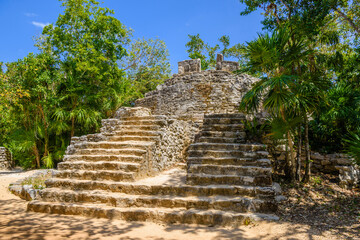 Mayan ruins in shadow of trees in jungle tropical forest Playa del Carmen, Riviera Maya, Yu atan, Mexico