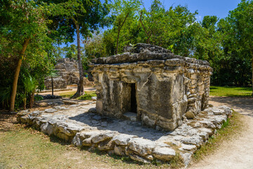 Mayan ruins in shadow of trees in jungle tropical forest Playa del Carmen, Riviera Maya, Yu atan, Mexico