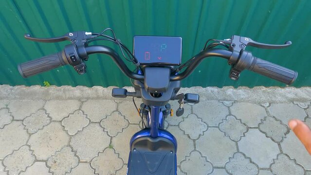 Moment of turning on the ignition e-bike. Turn the