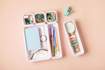 Desktop organization. Cleaning up messy stationary in plastic organizers for office and home desk