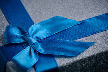 Blue ribbon and bow tied on the gift box.