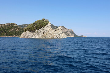 View to blue sea and rock islands on horizon. Deep water, background for traveling and vacation