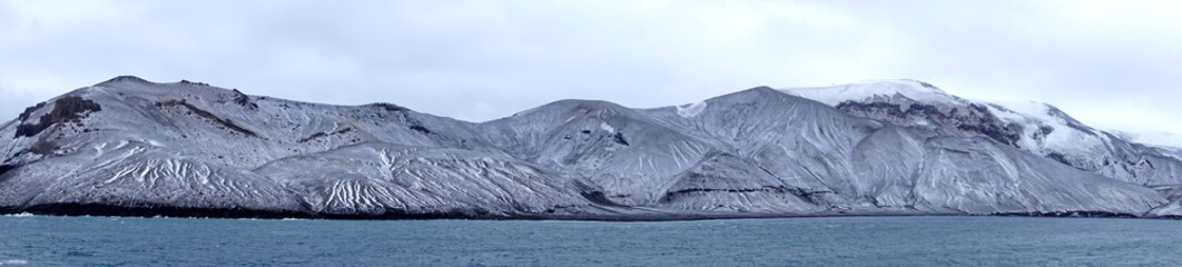 Panorama of snow dusted mountains above the crater bay in Deception Island, Antarctica