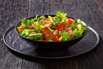 tofu salad with greens and vegetables in bowl