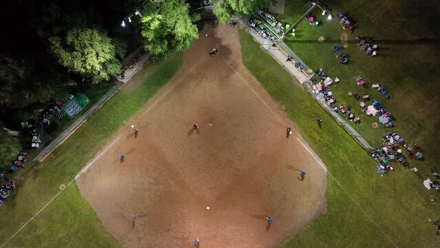 Aerial softball game night lights rural. Small rural community play softball. Village city celebration. Team spirit and teamwork. Sports, recreation and healthy exercise.