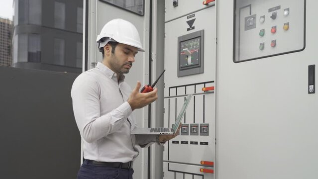 An engineer man or worker, people working in electrical room. Power energy motor machinery cabinets with panel in control or server room, operator station network in industry factory. Switchgear