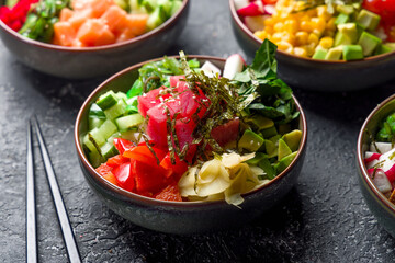 Ahi poke with tuna, avocado,cucumbers,tomatoes,chukka,sesame and nori macro close up on grey table
