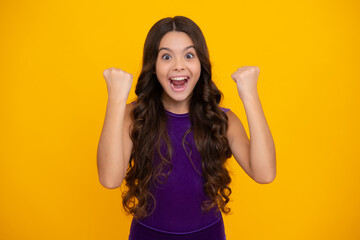 Portrait of teenage girl child doing winner gesture. Kid rejoicing, yes victory champion gesture, fist pump. Excited face, cheerful emotions of teenager girl.