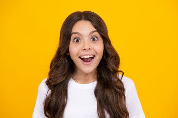 Amazed teen girl. Excited expression, cheerful and glad. Portrait of emotional positive teenage...