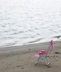 Fototapeta na wymiar chaise longue on a beach near waterline