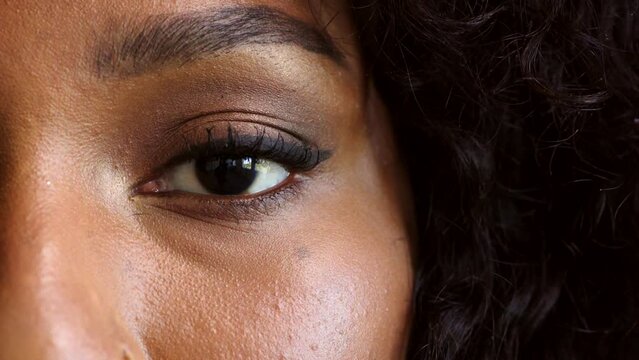 Portrait of a woman with an intense stare blinking while looking focused and thinking of ideas. Closeup of face and eyes of a serious black female with good vision feeling awake and aware of humanity