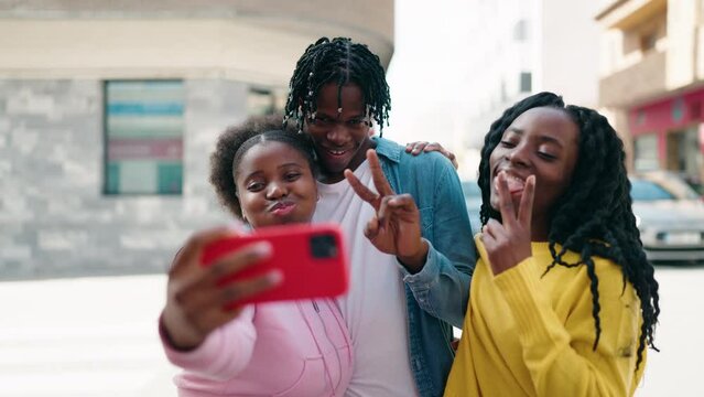 African american friends standing together making selfie by the smartphone at street