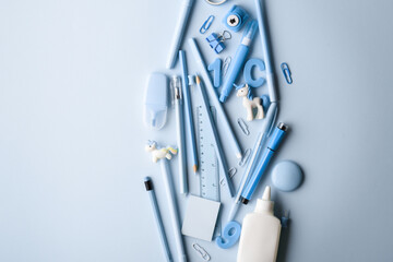 Fototapeta premium Background with various light blue stationery lying in the center. Back to school.