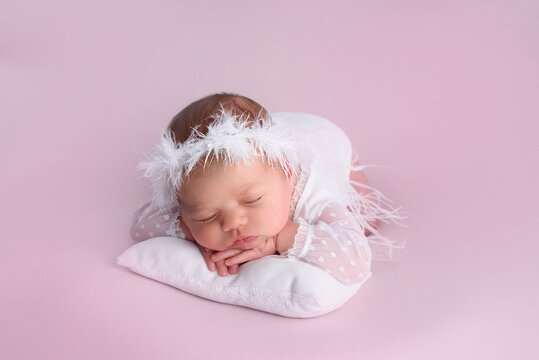 Close-up of a beautiful sleeping girl. Newborn baby girl sleeping on a blanket. Portrait of a beautiful, seven-day-old, newborn girl. Closeup photo