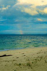 Calm blue seascape scenery with rainbow in the background in Pulau Besar, Mersing, Johor, Malaysia