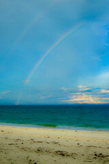 Calm blue seascape scenery with rainbow in the background in Pulau Besar, Mersing, Johor, Malaysia