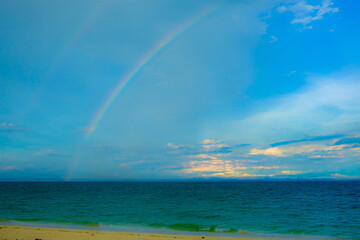 Calm blue seascape scenery with rainbow in the background in Pulau Besar, Mersing, Johor, Malaysia