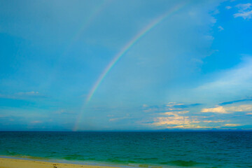 Calm blue seascape scenery with rainbow in the background in Pulau Besar, Mersing, Johor, Malaysia