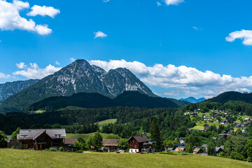 Beautiful idyllic panorama view of village near Altaussee with the peak Sarstein in background on a sunny summer day with blue sky cloud, Styria, Austria - 517275726