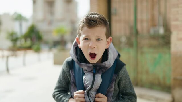 Blond child student screaming at street