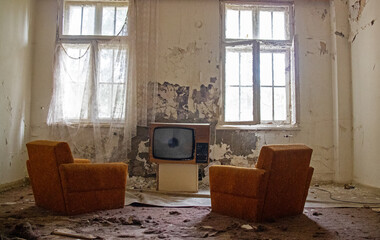 Glimpses of an old derelict industrial site with chair in foreground