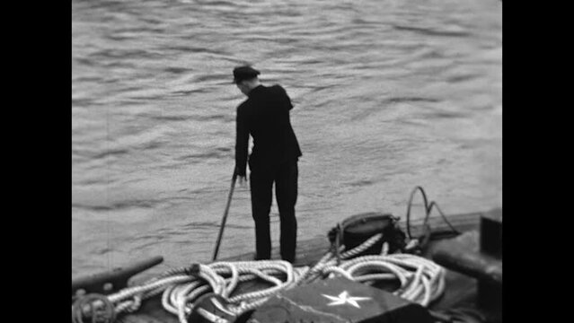 River Depth Check 1936 - A deckhand on a steamboat checks the depth of the water on the Yukon River in 1936.