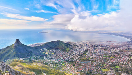 Copyspace landscape view of Lions Head and surroundings during the day in summer from above. Aerial view of the beautiful city of Cape Town with popular natural landmarks against a cloudy blu sky - Powered by Adobe