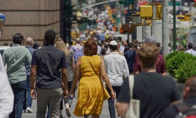 Crowd of people walking city street