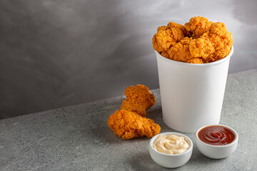 Crispy fried chicken in the bucket. Chicken bucket. - obrazy, fototapety, plakaty