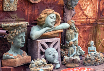 cement statues for sale, at an outdoor antique shop